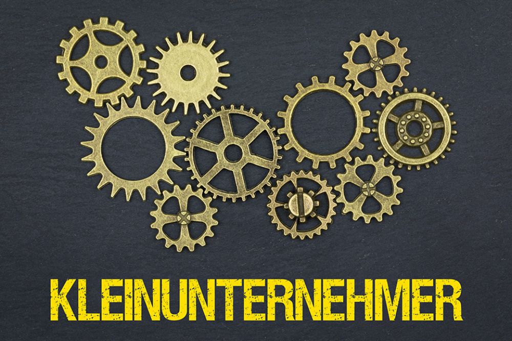 Zahnräder und Schriftzug Kleinunternehmer
